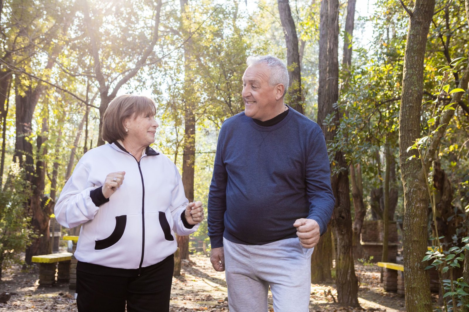 Older couple walking and talking in a park
