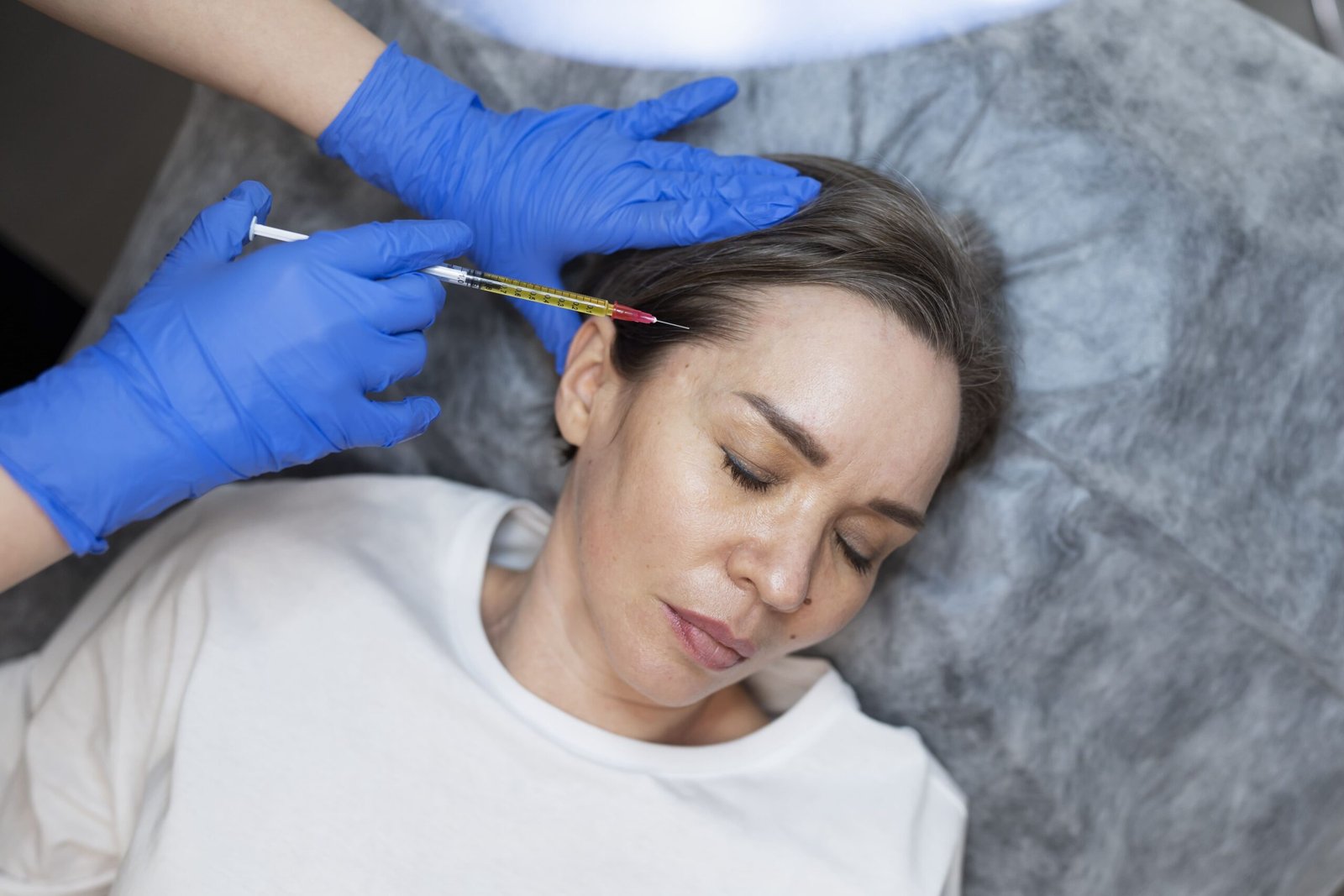 Patient receiving an injection in the forehead
